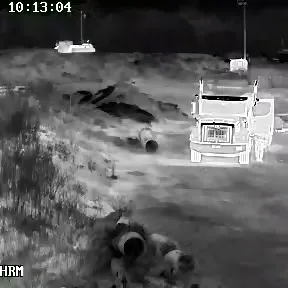 Thermal camera frame picking a truck and figures out of complete darkness